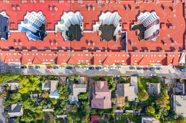 aerial top down view of roofs of apartment buildings and private houses in city residential area