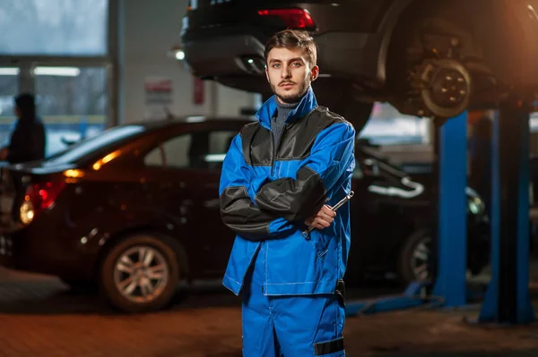 Jovem bonito mecânico de automóveis no trabalho — Fotografia de Stock