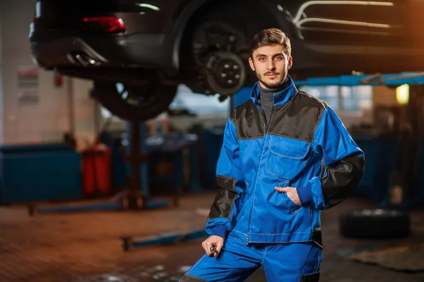 Joven mecánico de automóviles guapo en el trabajo — Foto de Stock