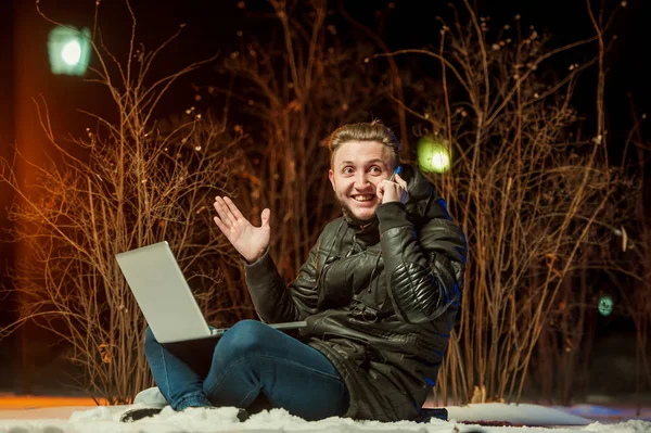 Knappe jongen met een computer's nachts — Stockfoto