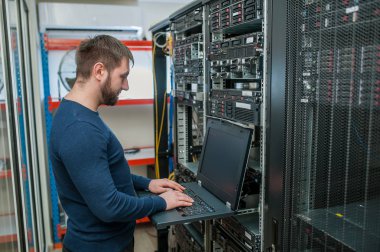 network engineer working in server room clipart