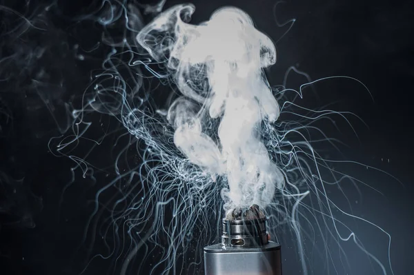 Electronic Cigarette on a black background and smoke from it — Stock Photo, Image