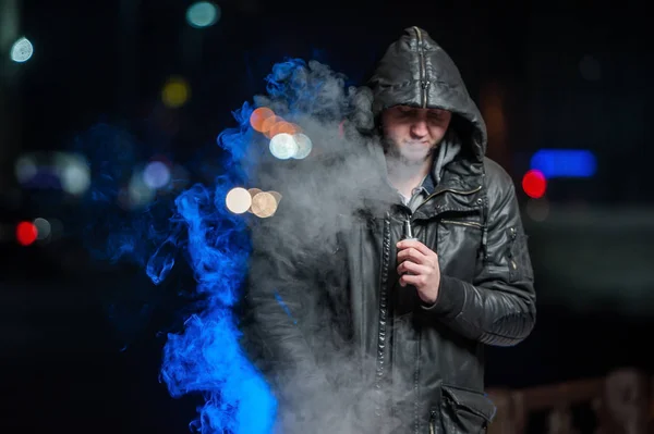 Handsome young man smoking electronic cigarette — Stock Photo, Image