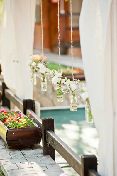 Las flores frescas en los floreros las cestas sobre la decoración de mesa — Foto de Stock