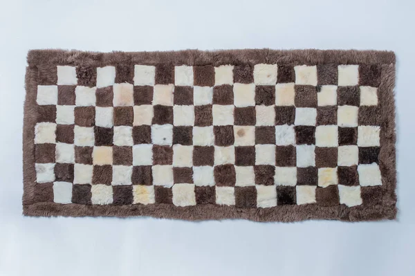 Bont wollen tapijt op een witte achtergrond — Stockfoto