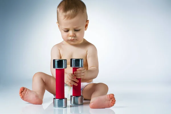 Baby with dumbbells — Stock Photo, Image