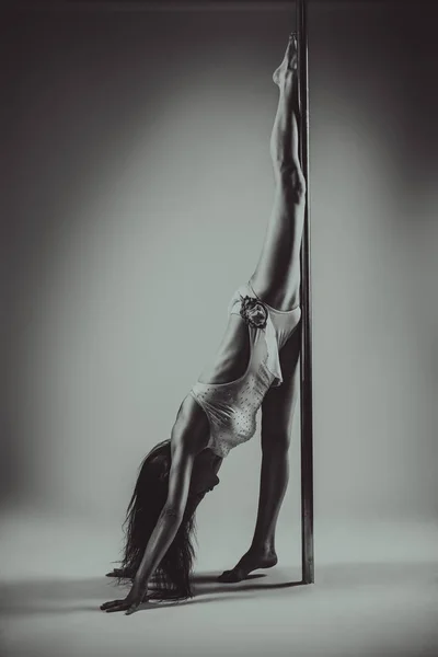 Young pole dancing woman