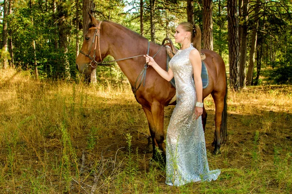 Girl in a beautiful dress is a horse — Stock Photo, Image