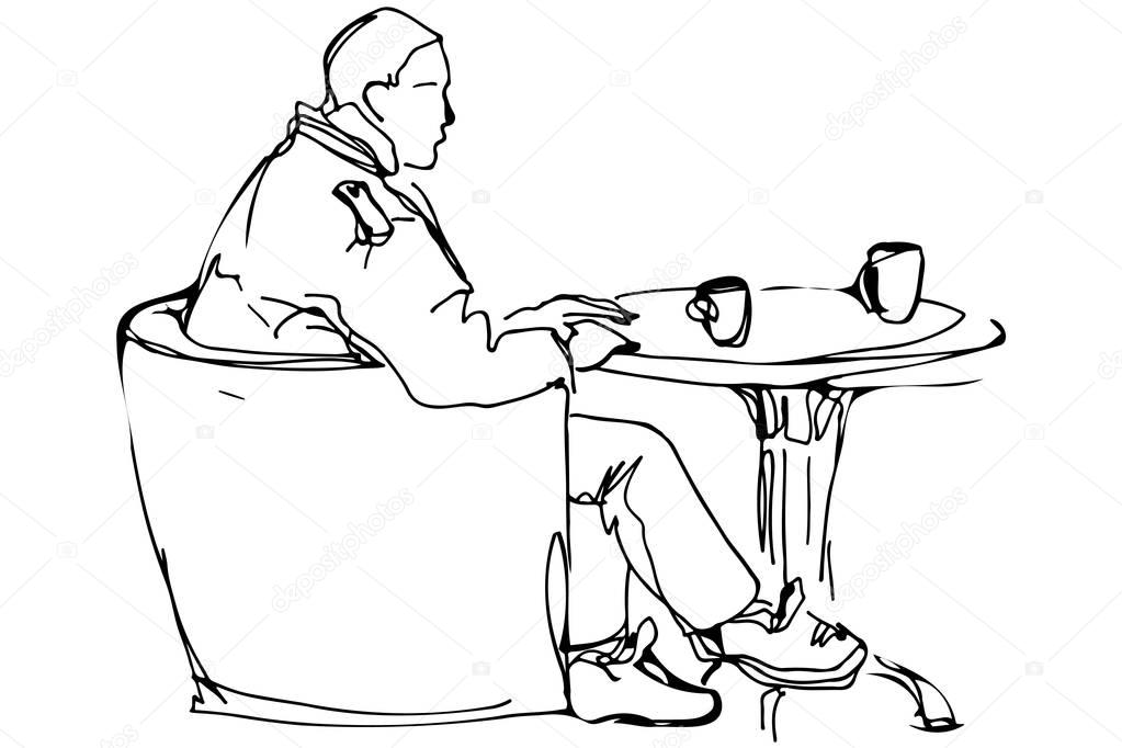  man at the round table in a cafe drinking coffee