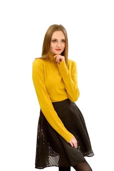 Beautiful young girl in a yellow sweater and a black skirt — Stock Photo, Image