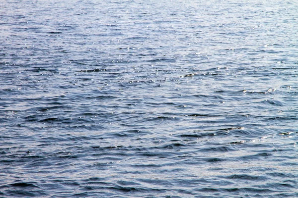 Water surface of the river with waves and sunlight reflections — Stock Photo, Image