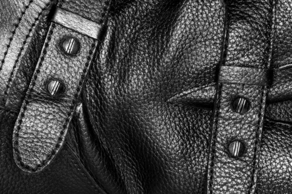 image of a buckle on a black leather boot