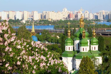Vydubychi Monastery with lilac blossom in Kyiv, Ukraine clipart