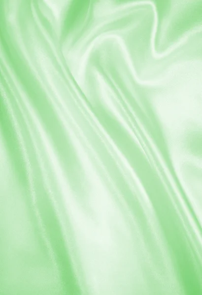 Hladké elegantní zelené hedvábí nebo satén textury pozadí — Stock fotografie
