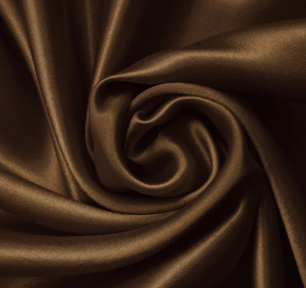 Glatte, elegante braune Seide oder Satin als Hintergrund. in Sepia getönt — Stockfoto