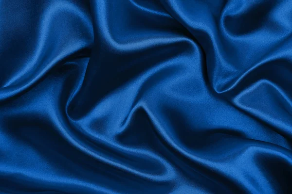 Ομαλή κομψό μπλε μετάξι ή υφή υφάσματος σατέν πολυτελείας, όπως abstra — Φωτογραφία Αρχείου