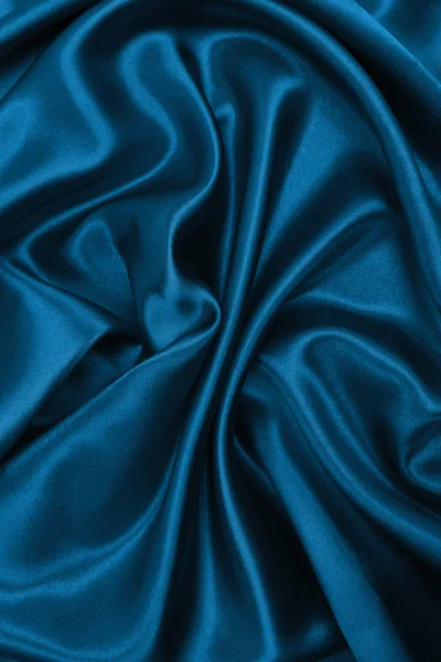 滑らかなエレガントな青い絹またはサテンの高級布テクスチャは abstra として — ストック写真