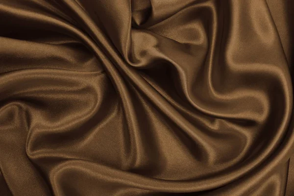 Гладкая элегантная коричневая шелковая или атласная текстура в виде абстрактной спинки — стоковое фото