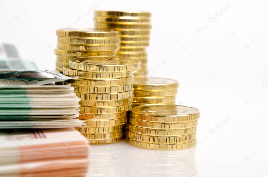 Russian money rubles coins and banknotes on a light background.