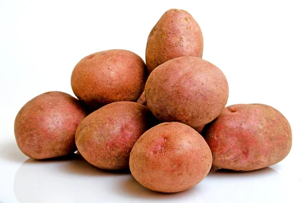 Aardappelen roze op een lichte roze achtergrond. — Stockfoto