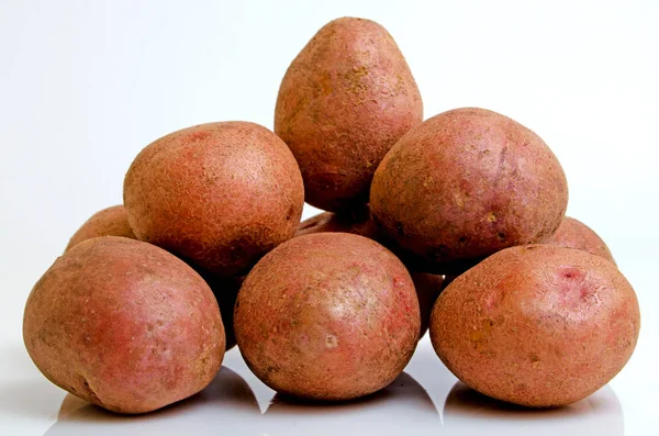 Potatoes pink on a light pink background. — Stock Photo, Image