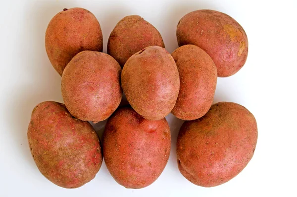 Aardappelen roze op een lichte roze achtergrond. — Stockfoto
