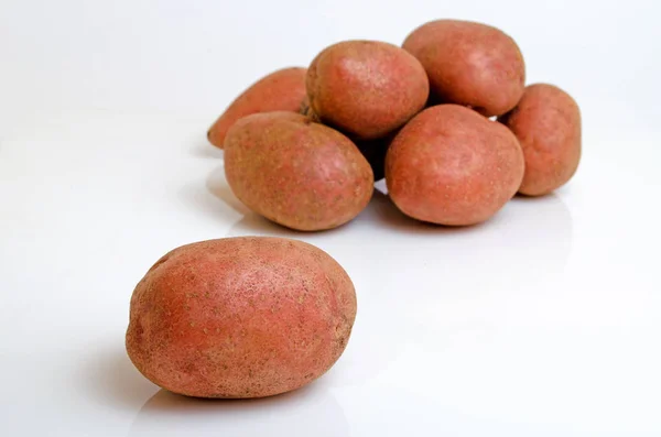 Aardappelen roze op een lichte roze achtergrond. — Stockfoto