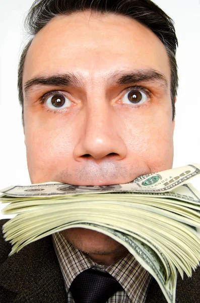 Zakenman met pack dollars in een mond. — Stockfoto