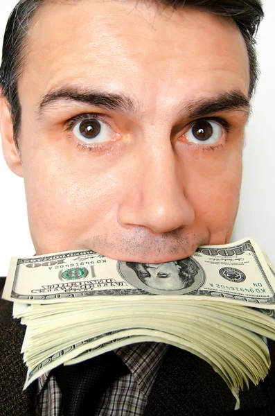 Businessman with pack of dollars in a mouth. — Stock Photo, Image