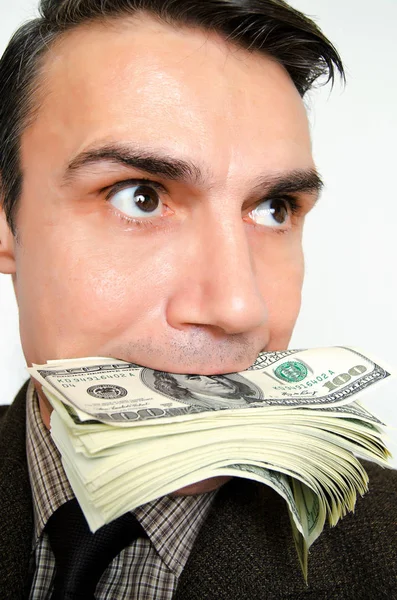 Businessman with pack of dollars in a mouth. Royalty Free Stock Photos