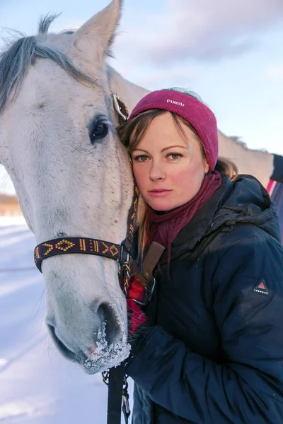 Young beautiful woman petting her big white horse — Stock Photo, Image