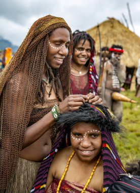 Endonezya, Papua Yeni Gine, Wamena, Irian Jaya, 20 Ağustos 2018: Wamena, Yeni Gine 'de düzenlenen Baliem Vadisi festivalinde üç papualı kadın. Festivale genellikle yüzlerce yerli kabile katıldı..