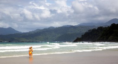 PHILIPPINES, PALAWAN, DECEMBER, 30, 2019 - Couple in the coastal waves of the Indian Ocean on Palawan island, Philippines