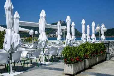 Wonderful cafe near the La Concha beach with view to the Bay of Biscay and Mount Igueldo in San Sebastian, Donostia, Spain clipart