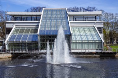 LATVIA, RIGA, APRYL, 2018 - Bina Riga Authority 'den Freeport ve önündeki çeşme Riga şehir kanalında Kronvalda Park Bastejkalns, Letonya.