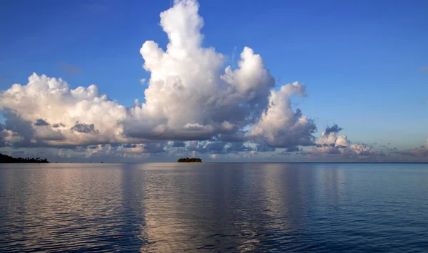 Beautiful cumulus clouds over Pacific ocean in the Leeward group of the Society Islands of French Polynesia.