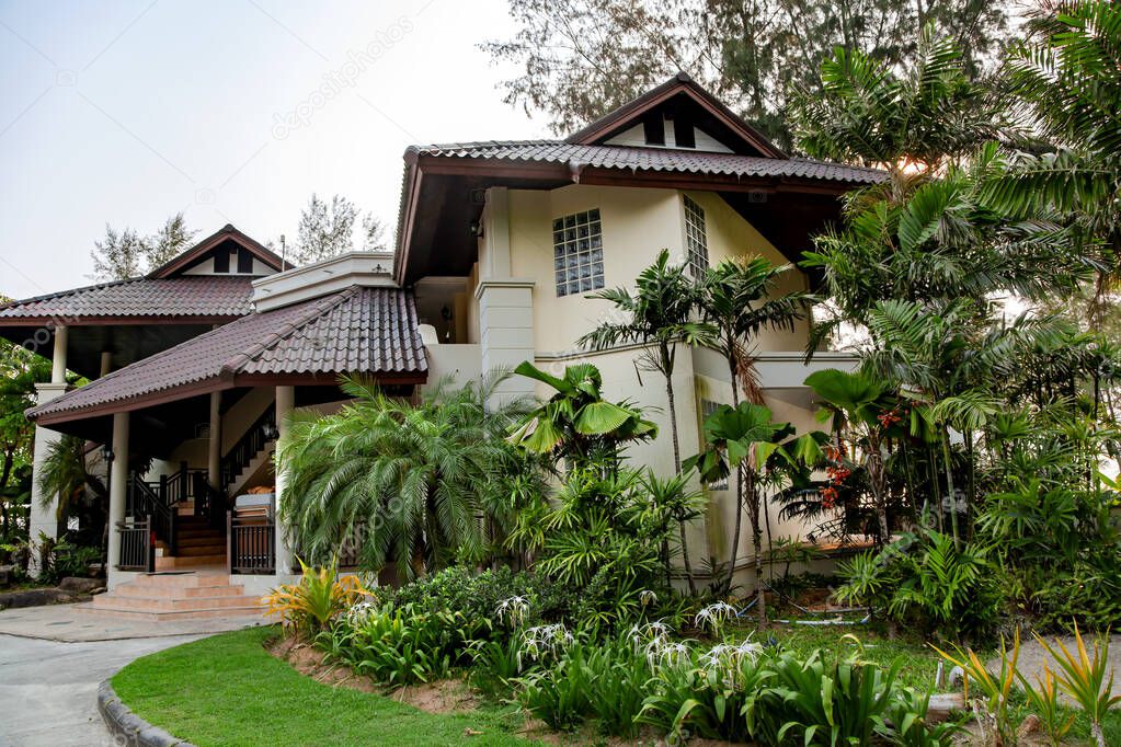 Modern two-story cottage surrounded by a beautiful tropical park on Koh Chang island in Thailand.