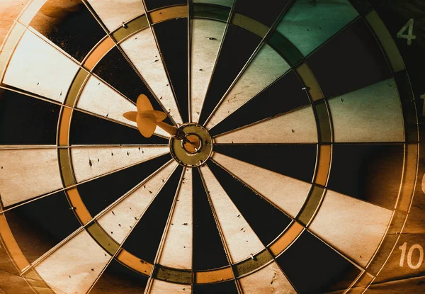 Vintage dart board on dark wall grunge — Stock Photo, Image