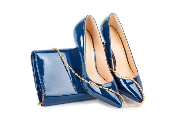 Beautiful blue shoes with clutches on white background
