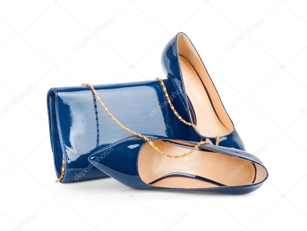 Beautiful blue shoes with clutches on white background