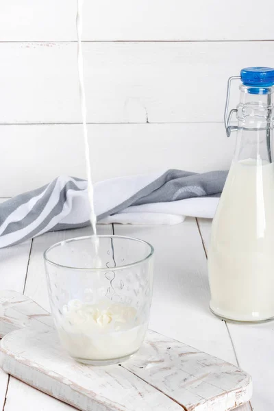 Old  vintage style bottles with fresh milk on  white wooden table — Stock Photo, Image