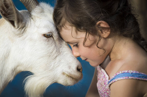 Countryside young girl with goat