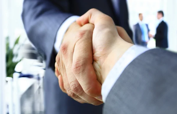 Närbild av en business handslag i moderna kontor — Stockfoto