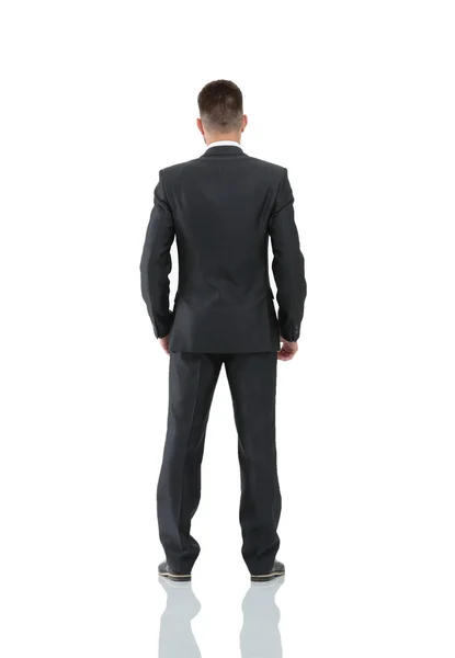 Businessman from the back - looking at something over a white ba — Stock Photo, Image