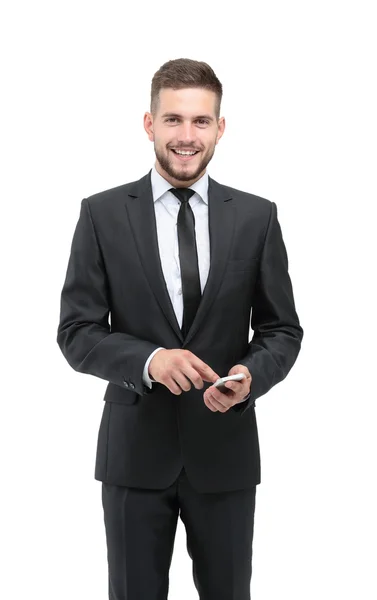 Pohledný podnikatel v obleku pomocí telefon v kanceláři — Stock fotografie
