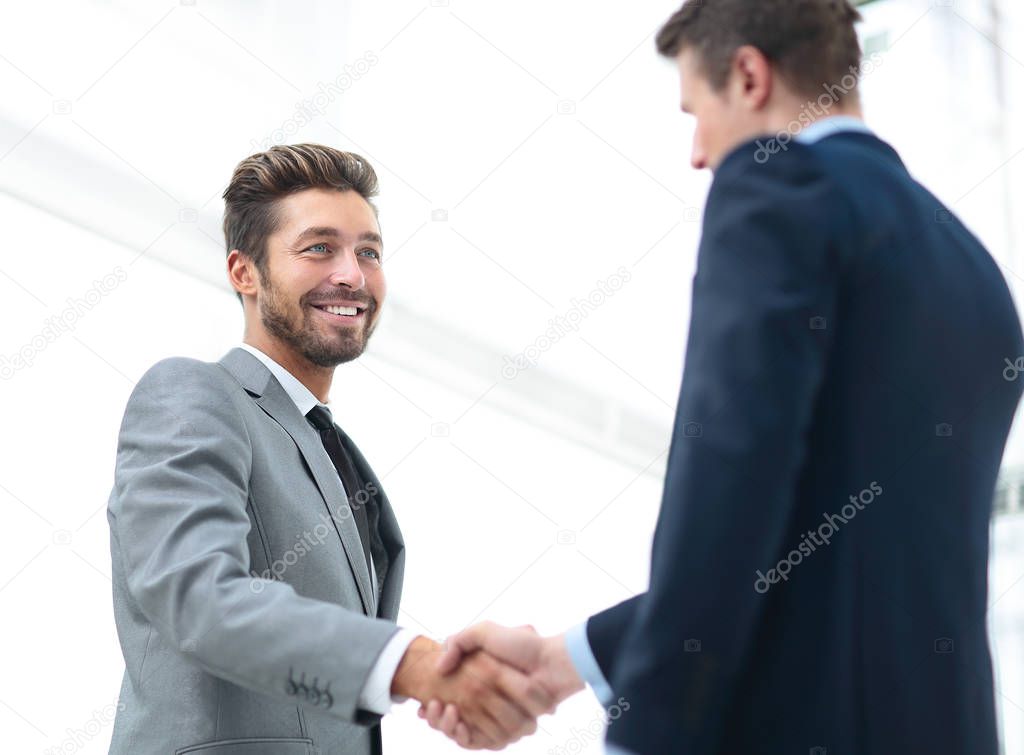 Closeup of a business handshake. Business people shaking hands, finishing up a meeting