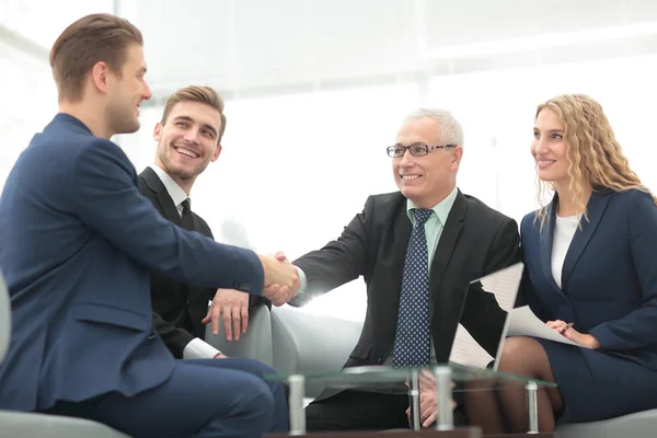 In a sign of cooperation, the partners shake hands after signing — Stock Photo, Image