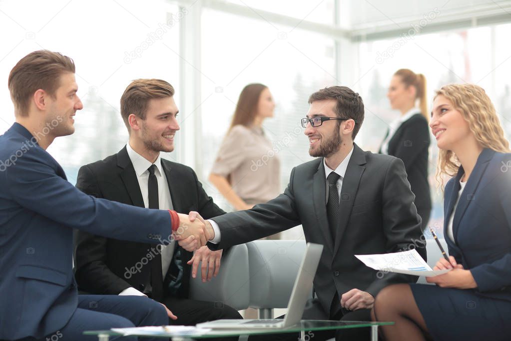 Handshake between businesspeople in a modern office