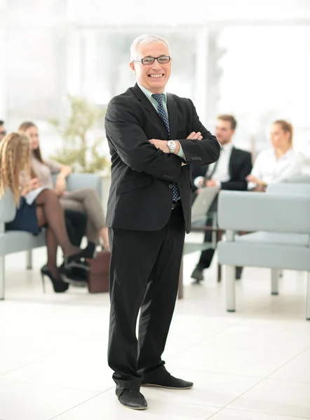 Portrait of happy businessman with  colleagues interacting on ba — Stock Photo, Image