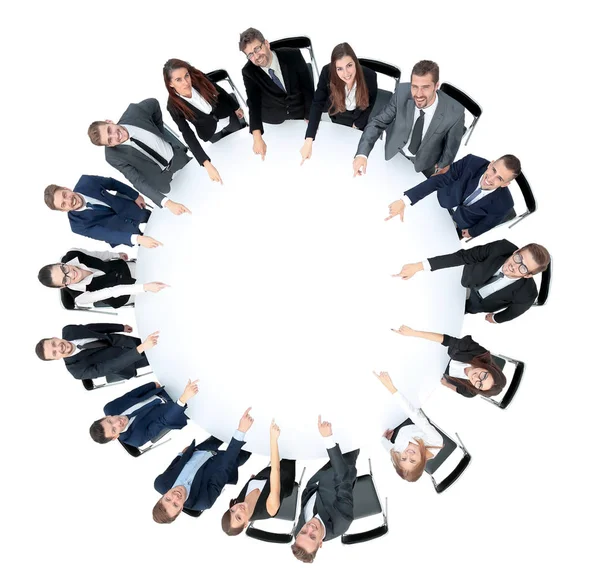 Diverse group pf young business people seated round a table disc — Stock Photo, Image